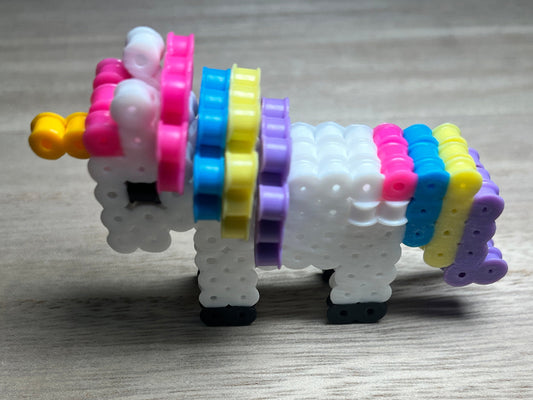 Colorful handmade 3D perler toy shaped like a unicorn
